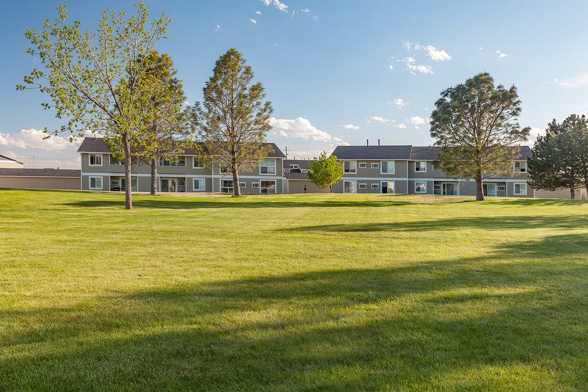a view of an open field in front of an apartment building at Shiloh Glen, Billings, MT 59102